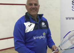 An image of David Taylor standing on a squash court promoting a junior coaching initiative at Forres Squash Club.